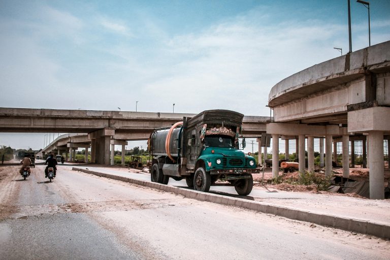 Tanker truck and vehicles on a highway in Kotri, Sindh, Pakistan. Urban transportation system.